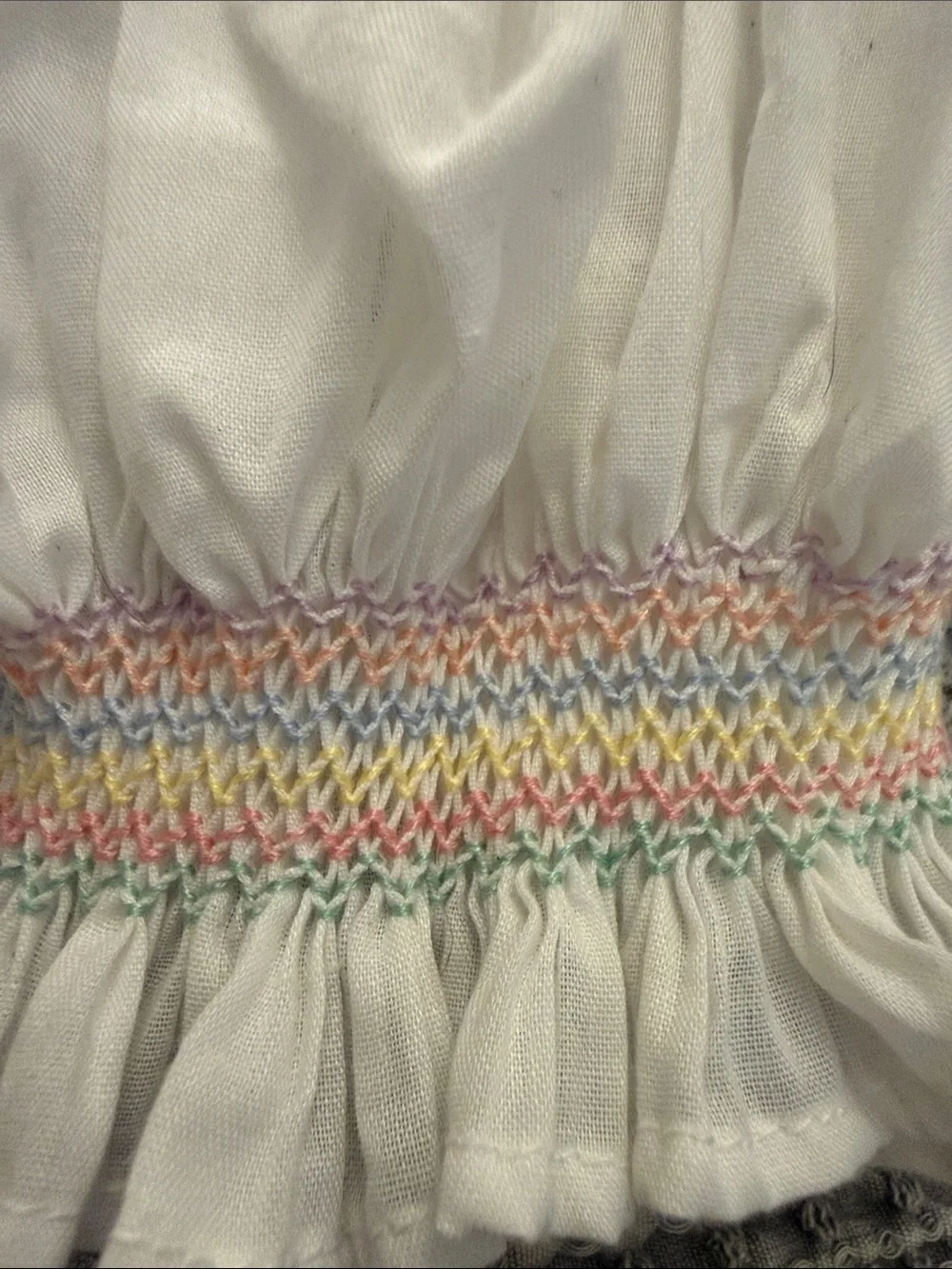 White Smocked Baby Bonnet with Pastel Rainbow Stitching